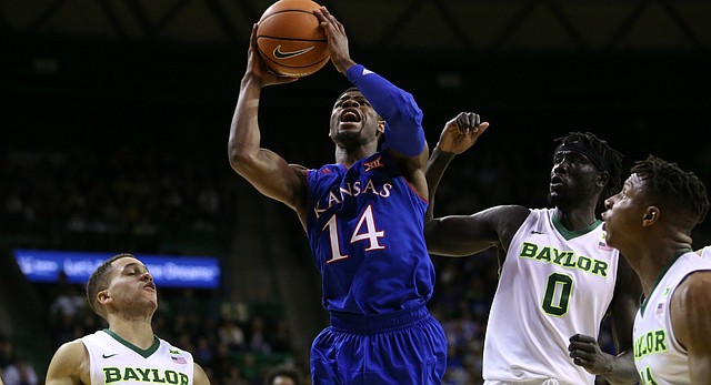Kansas guard Malik Newman (14) heads to the bucket between several Baylor players during the first half, Saturday, Feb. 11, 2018 at Ferrell Center in Waco, Texas.