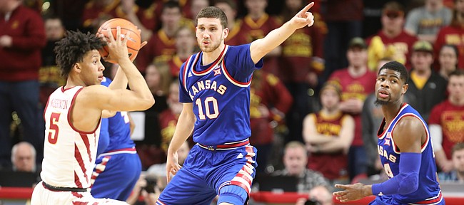 Kansas guard Sviatoslav Mykhailiuk (10) directs his teammates on defense as he guards Iowa State guard Lindell Wigginton (5) during the first half, Tuesday, Feb. 13, 2018 at Hilton Coliseum in Ames, Iowa. At right is Kansas guard Malik Newman (14).