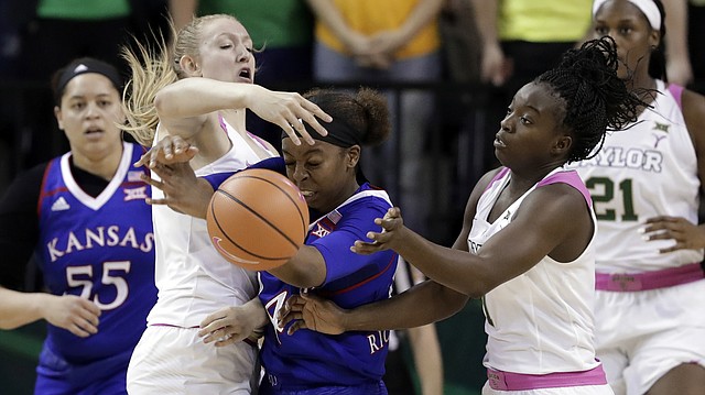 Baylor's Lauren Cox, left, and Dekeiya Cohen, right, combine to strip the ball away from Kansas' Austin Richardson, center, in the second half of an NCAA college basketball game Saturday, Feb. 17, 2018, in Waco, Texas. (AP Photo/Tony Gutierrez)