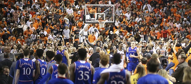 Kansas forward Mitch Lightfoot (44) wades through the masses of screaming Oklahoma State players and fans following the Cowboys' 82-64 win over the Jayhawks on Saturday, March 3, 2018 at Gallagher-Iba Arena, in Stillwater, Okla.