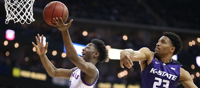Kansas guard Marcus Garrett (0) goes to the bucket against Kansas State guard Amaad Wainright (23) during the second half, Friday, March 9, 2018 at Sprint Center in Kansas City, Mo.