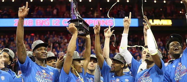 Kansas guard Devonte' Graham (4) hoists the Big 12 trophy following the JayhawksÕ 81-70 win over the Mountaineers in the championship game of the Big 12 Tournament, Saturday, March 10, 2018 at Sprint Center in Kansas City, Mo.
