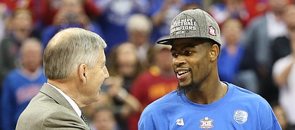 Kansas guard Malik Newman (14) is presented with the Big 12 Tournament MVP trophy by commissioner Bob Bowlsby following the Jayhawks' win.
