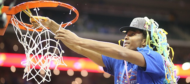 Kansas guard Devonte' Graham (4) cuts down his share of the net following the JayhawksÕ 81-70 win over the Mountaineers in the championship game of the Big 12 Tournament, Saturday, March 10, 2018 at Sprint Center in Kansas City, Mo.