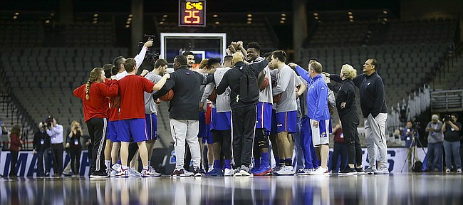 The Kansas Jayhawks come in for a team huddle toward the beginning of practice on Thursday, March 22, 2018 at CenturyLink Center in Omaha, Neb.