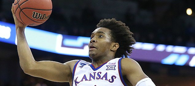 Kansas guard Devonte' Graham (4) heads in for a bucket during the first half, Friday, March 23, 2018 at CenturyLink Center in Omaha, Neb.