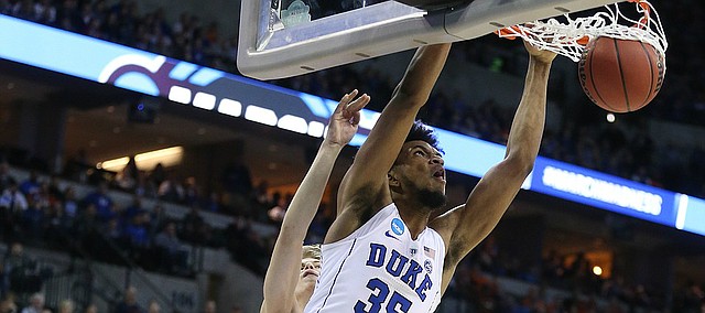 Duke forward Marvin Bagley III (35) throws down a lob jam over Syracuse center Paschal Chukwu (13) during the second half, Friday, March 23, 2018 at CenturyLink Center in Omaha, Neb.