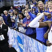 Kansas guard Lagerald Vick (2) flexes as he celebrates with his Final Four berth with his family following the Jayhawks' 85-81 overtime victory over Duke on Sunday in Omaha, Neb.