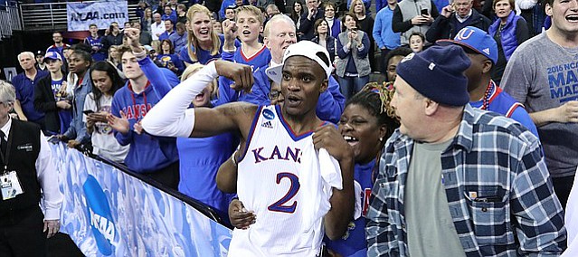 Kansas guard Lagerald Vick (2) flexes as he celebrates with his Final Four berth with his family following the Jayhawks' 85-81 overtime victory over Duke on Sunday in Omaha, Neb.