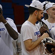 Sophomore guards Sam Cunliffe and Malik Newman hold an Elite Eight victory trophy at Allen Fieldhouse after the Jayhawk's 85-81 victory over Duke in Omaha, Neb. earlier in the day on Sunday, March 25, 2018. KU will face Villanova in the Final Four round of the NCAA tournament in San Antonio, Texas on Saturday.