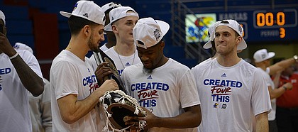 Sophomore guards Sam Cunliffe and Malik Newman hold an Elite Eight victory trophy at Allen Fieldhouse after the Jayhawk's 85-81 victory over Duke in Omaha, Neb. earlier in the day on Sunday, March 25, 2018. KU will face Villanova in the Final Four round of the NCAA tournament in San Antonio, Texas on Saturday.