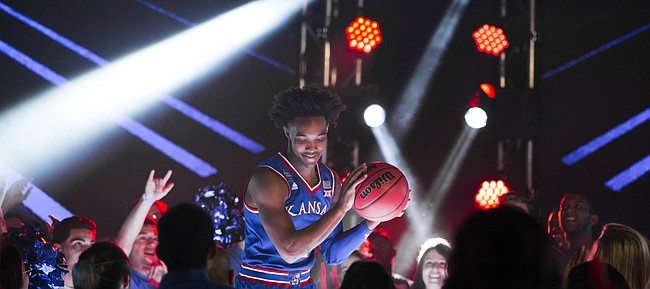 Kansas guard Devonte' Graham pump fakes with a ball as he dances on a stage before fans during a video recording with Turner CBS on Thursday, March 29, 2018 at the Alamodome in San Antonio, Texas.