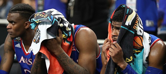 Kansas guard Malik Newman (14) peeks out from a towel as he watches the final seconds of the Jayhawks' 95-79 loss to Villanova on Saturday, March 31, 2018 at the Alamodome in San Antonio, Texas.