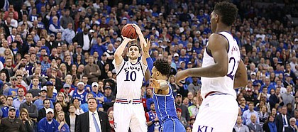 Kansas guard Sviatoslav Mykhailiuk (10) puts up a three to force overtime with seconds remaining in regulation, Sunday, March 25, 2018 at CenturyLink Center in Omaha, Neb.