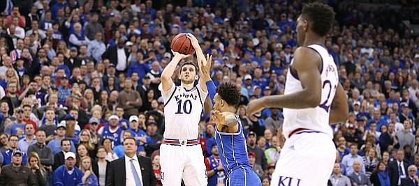 Kansas guard Sviatoslav Mykhailiuk (10) puts up a three to force overtime with seconds remaining in regulation, Sunday, March 25, 2018 at CenturyLink Center in Omaha, Neb.