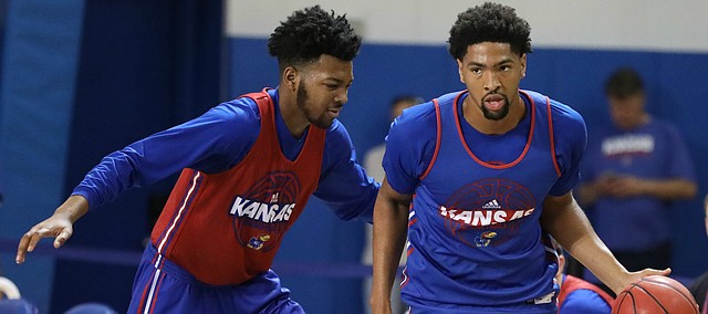 Blue Team forward Dedric Lawson (1) dribbles past Red Team forward K.J. Lawson during a scrimmage on Tuesday, June 5, 2018, at the Horejsi Athletic Center.