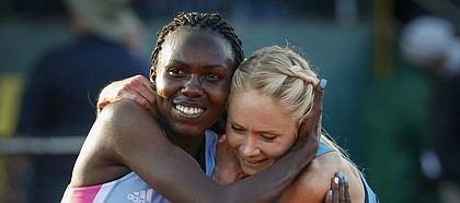 Kansas' Sharon Lokedi, left, is hugged by New Mexico's Alice Wright after Lokedi's win in the women's 10,000 meters during the second day of the NCAA Outdoor Track and Field Championships at Hayward Field on Thursday, June 7, 2018, in Eugene, Ore. Wright finished in fourth place. (Andy Nelson/The Register-Guard via AP)

