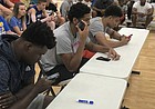 Current Jayhawks, from left to right, Udoka Azubuike, Dedric Lawson and Quentin Grimes showed up at Sports Pavilion Lawrence on Friday night and chipped in at the Hardwood Classic by judging the 2018 slam dunk contest. KU sophomore Marcus Garrett also helped hand out scores. 