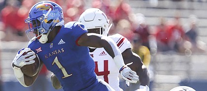 Kansas running back Pooka Williams Jr. (1) is finally dragged down by the Rutgers defense after a long run during the first quarter on Saturday, Sept. 15, 2018 at Memorial Stadium.