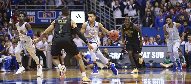 Kansas guard Devon Dotson (11) drives the ball up the court against Vermont guard Skyler Nash (1) during the first half, Monday, Nov. 12, 2018 at Allen Fieldhouse.