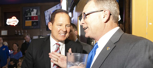Newly-hired Kansas football coach Les Miles, left, and Kansas Athletic Director Jeff Long talk during the "Hawk Talk" radio show on Sunday, Nov. 18, 2018, at Johnny's West in Lawrence.