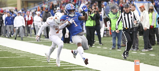 Kansas running back Pooka Williams Jr. (1) leaves Texas defensive back Caden Sterns (7) behind as he skips into the end zone for a touchdown during the fourth quarter on Friday, Nov. 23, 2018 at Memorial Stadium.