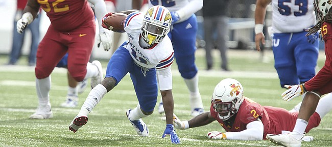 Kansas wide receiver Steven Sims Jr. (11) tries to regain his footing as the Iowa State defense closes in during the first quarter, Saturday, Nov. 3, 2018 at Memorial Stadium.