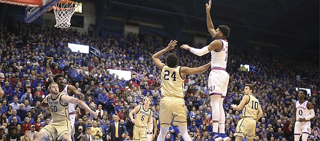 Kansas forward Dedric Lawson (1) turns for a shot over Wofford forward Keve Aluma (24) during the first half on Tuesday, Dec. 4, 2018 at Allen Fieldhouse.