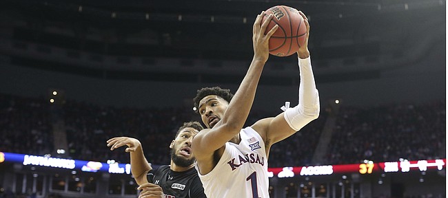 Kansas forward Dedric Lawson (1) turns to the bucket after catching the ball in the paint while defended by New Mexico State forward Johnny McCants (35) during the second half on Saturday, Dec. 8, 2018 at Sprint Center.