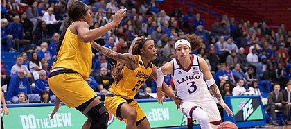KU senior Jessica Washington (3) makes a move past Grambling State Kendriana Washington (20) in the second quarter Sunday afternoon in Allen Fieldhouse.