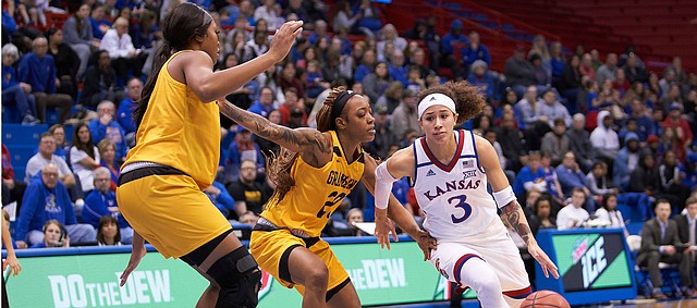 KU senior Jessica Washington (3) makes a move past Grambling State Kendriana Washington (20) in the second quarter Sunday afternoon in Allen Fieldhouse.