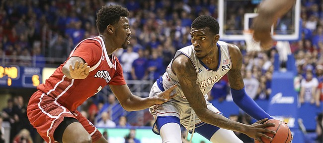 Kansas guard Lagerald Vick (24) looks to make a mov against South Dakota guard Triston Simpson (3) during the first half, Tuesday, Dec. 18, 2018 at Allen Fieldhouse.