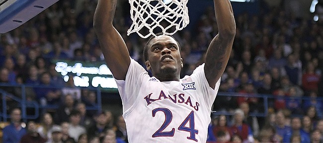 Kansas guard Lagerald Vick throws down a two handed dunk Saturday.