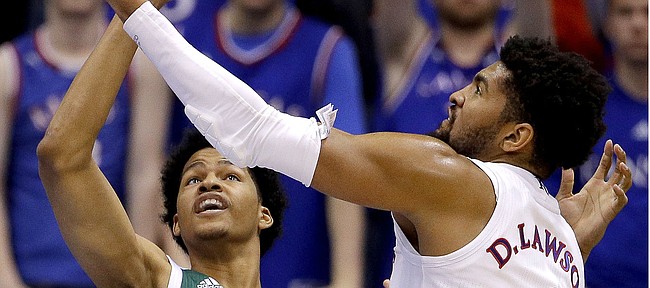 Eastern Michigan's Jalen King (30) and Kansas' Dedric Lawson (1) battle for a rebound during the second half of an NCAA college basketball game Saturday, Dec. 29, 2018, in Lawrence, Kan. Kansas won 87-63.