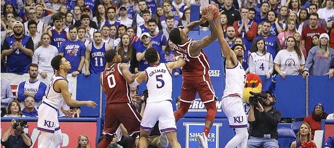 Kansas forward Dedric Lawson (1) gets a hand on a late shot from Oklahoma forward Kristian Doolittle (21) with seconds remaining in the game, Wednesday, Jan. 2, 2019 at Allen Fieldhouse.