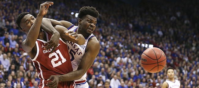 Kansas center Udoka Azubuike (35) and Oklahoma forward Kristian Doolittle (21) wrestle for position on a loose ball during the first half, Wednesday, Jan. 2, 2019 at Allen Fieldhouse.