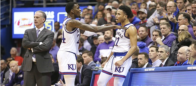 Kansas guard Lagerald Vick (24) gives a celebratory shove to Kansas guard Devon Dotson (11) after Dotson's rejection of a TCU shot with seconds remaining in the game, Wednesday, Jan. 9, 2019 at Allen Fieldhouse. At left is TCU head coach Jamie Dixon.