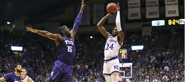 Kansas guard Lagerald Vick (24) puts up a three over TCU forward JD Miller (15) during the first half, Wednesday, Jan. 9, 2019 at Allen Fieldhouse.