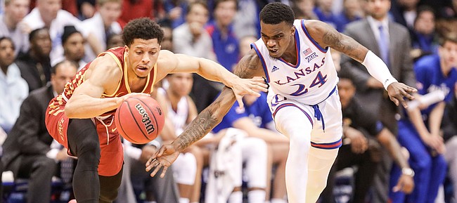 Kansas guard Lagerald Vick (24) reaches for a near steal from Iowa State guard Lindell Wigginton (5) during the first half, Monday, Jan. 21, 2019 at Allen Fieldhouse.