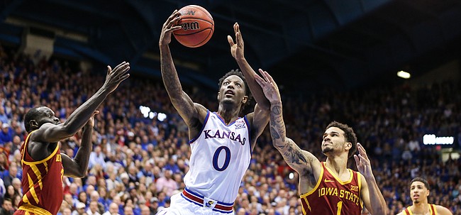 Kansas guard Marcus Garrett (0) gets in for a bucket between Iowa State guard Marial Shayok (3) and Iowa State guard Nick Weiler-Babb (1) during the second half, Monday, Jan. 21, 2019 at Allen Fieldhouse.