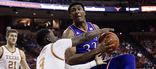 Kansas forward David McCormack (33) is pressured by Texas guard Courtney Ramey (3) during the first half on an NCAA college basketball game in Austin, Texas, Tuesday, Jan. 29, 2019. (AP Photo/Eric Gay)