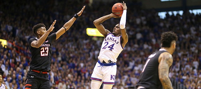 Kansas guard Lagerald Vick (24) fades back for a shot over Texas Tech guard Jarrett Culver (23) during the first half, Saturday, Feb. 2, 2019 at Allen Fieldhouse.
