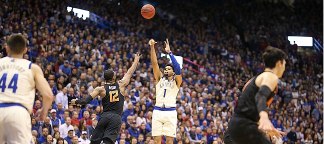 Kansas forward Dedric Lawson (1) puts up a three over Oklahoma State forward Cameron McGriff (12) during the first half, Saturday, Feb. 9, 2019 at Allen Fieldhouse.