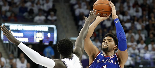 TCU forward Lat Mayen (11) defends as Kansas forward Dedric Lawson (1) attempts a shot in the first half of an NCAA college basketball game in Fort Worth, Texas, Monday, Feb. 11, 2019. (AP Photo/Tony Gutierrez)