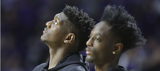 Kansas forward Silvio De Sousa, who was recently ruled ineligible by the NCAA, watches the video board along side injured teammate Marcus Garrett before tipoff against Kansas State, Tuesday, Feb. 5, 2019 at Bramlage Coliseum.