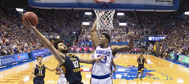 Kansas forward David McCormack (33) soars in to block a shot from West Virginia guard Jermaine Haley (10) during the second half, Saturday, Feb. 16, 2019 at Allen Fieldhouse.