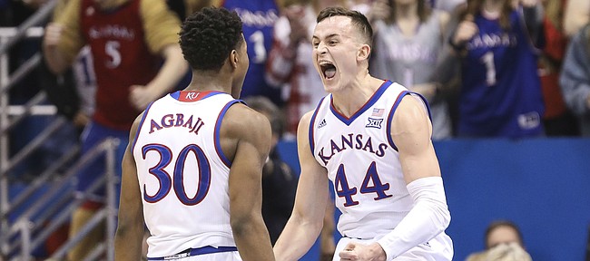 Kansas forward Mitch Lightfoot (44) celebrates with Kansas guard Ochai Agbaji (30) after drawing a charge against Kansas State during the first half, Monday, Feb. 25, 2019 at Allen Fieldhouse.
