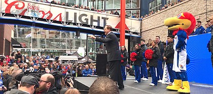 Kansas football coach Les Miles screams into his microphone while firing up the KU-friendly crowd at a pep rally for the Big 12 tournament on March 14, 2019, in Kansas City, Mo.