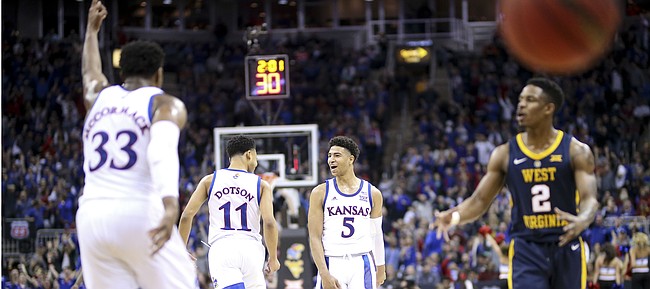 Kansas guard Quentin Grimes (5) celebrates with Kansas guard Devon Dotson (11) after connecting on a three pointer during the first half, Friday, March 15, 2019 at Sprint Center in Kansas City, Mo.