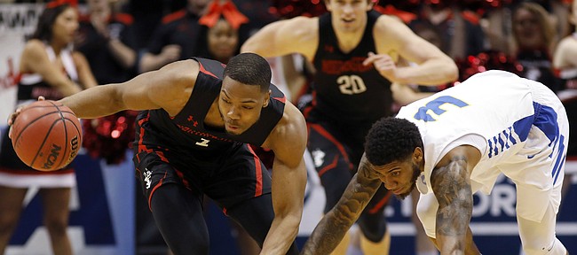 Northeastern's Shawn Occeus, left, drives down the court against Hofstra's Justin Wright-Foreman in the first half of an NCAA college basketball game at the Colonial Athletic Association men's basketball championship, Tuesday, March 12, 2019, in North Charleston, S.C. (AP Photo/Mic Smith)
